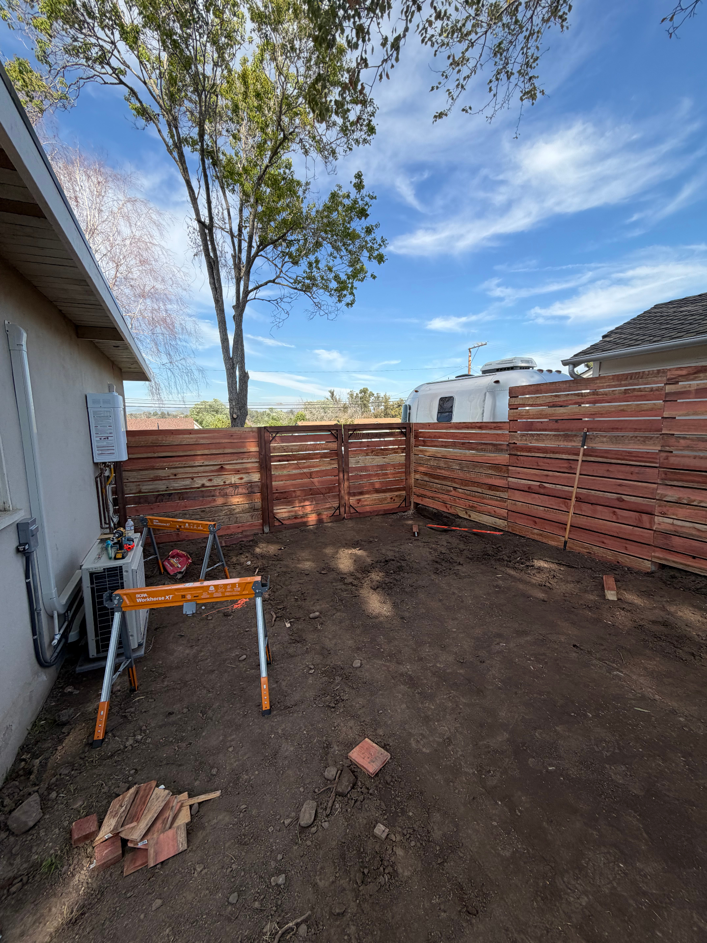 Backyard cedar privacy fence and gate installation in progress
