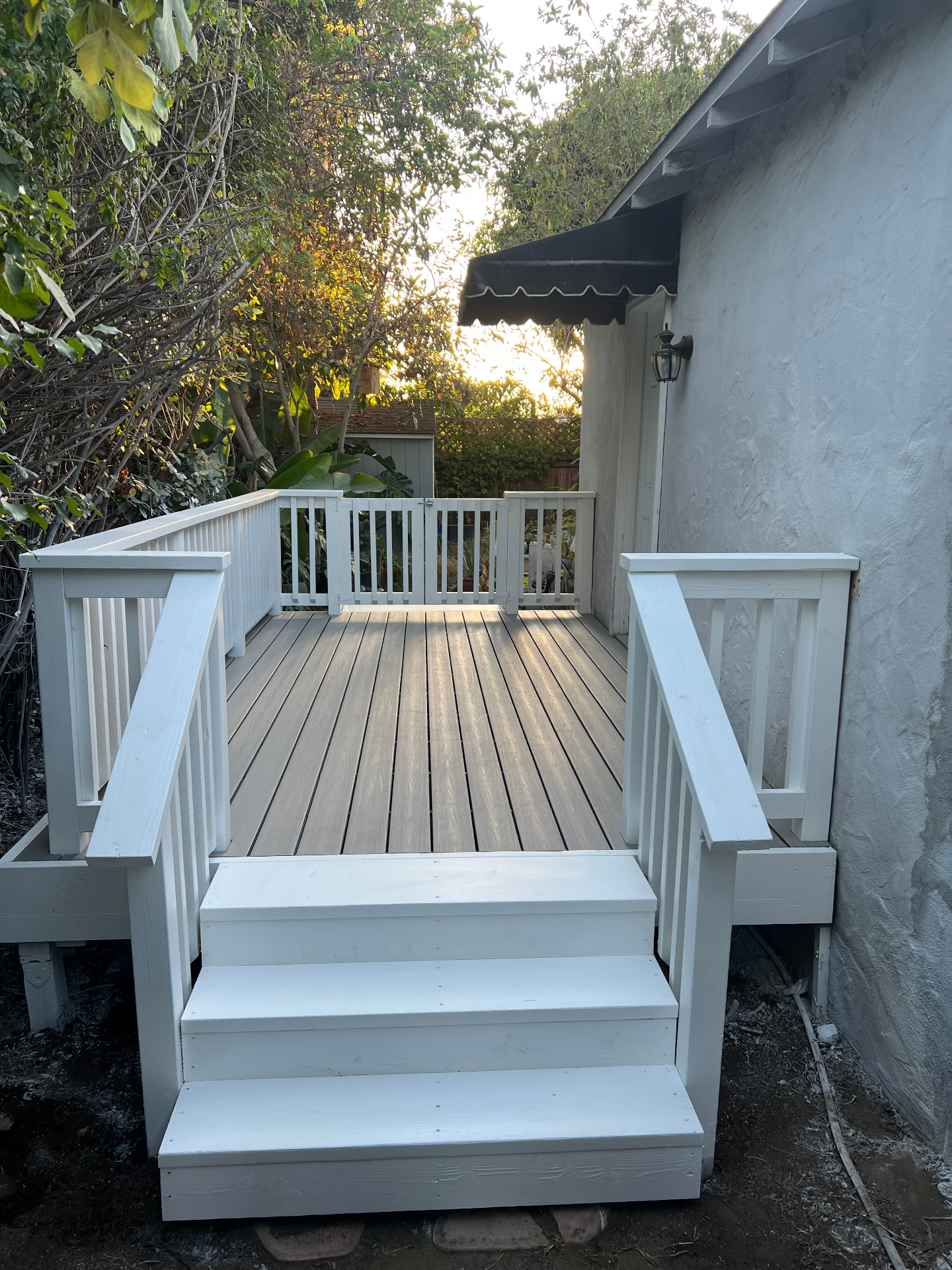 Finished backyard deck with painted railings and steps